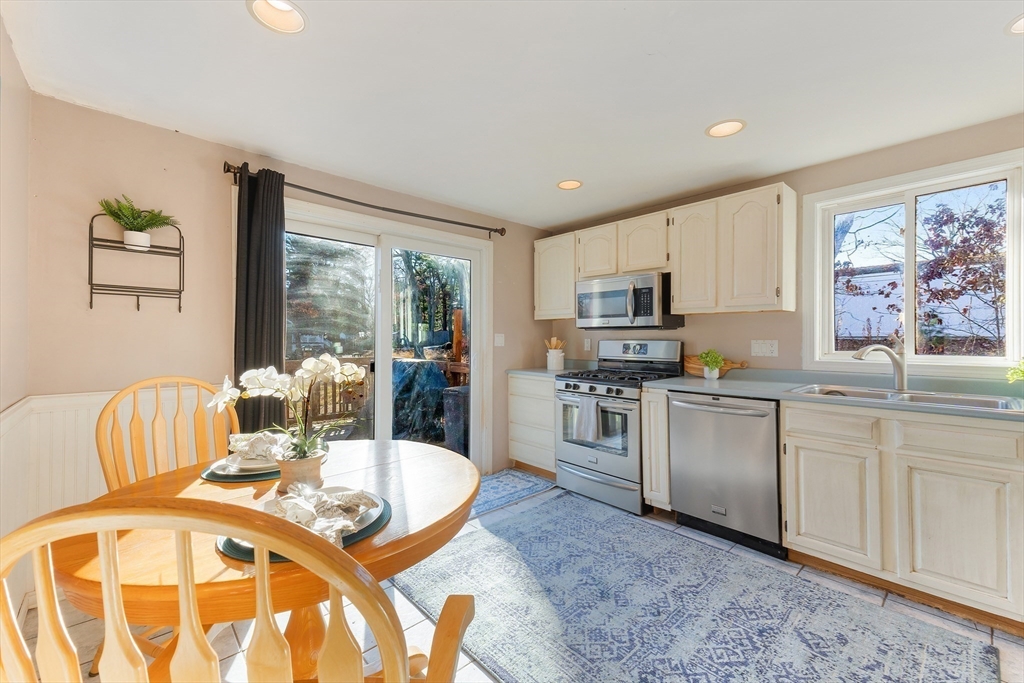 3 Riverside Road Billerica, MA 01821 - Photo 7 of 42 a kitchen with sink refrigerator dining table and chairs
