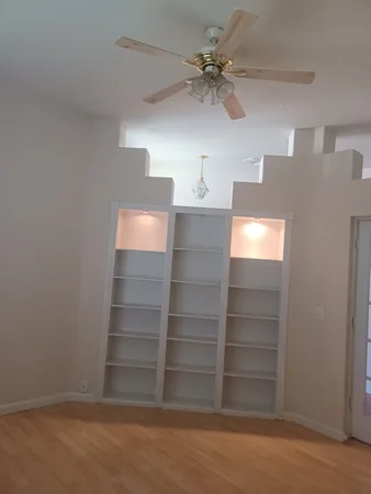 a view of walk in closet with empty racks
