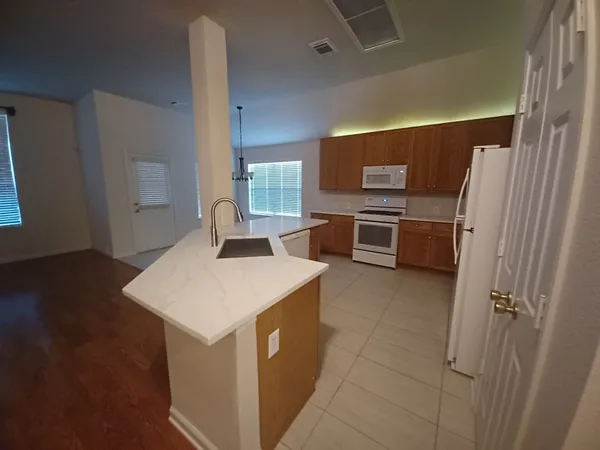 a kitchen with stainless steel appliances a stove refrigerator sink and a oven