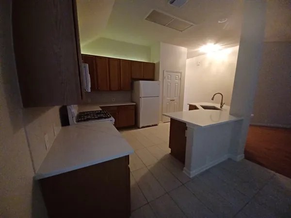 a kitchen with a refrigerator and a sink