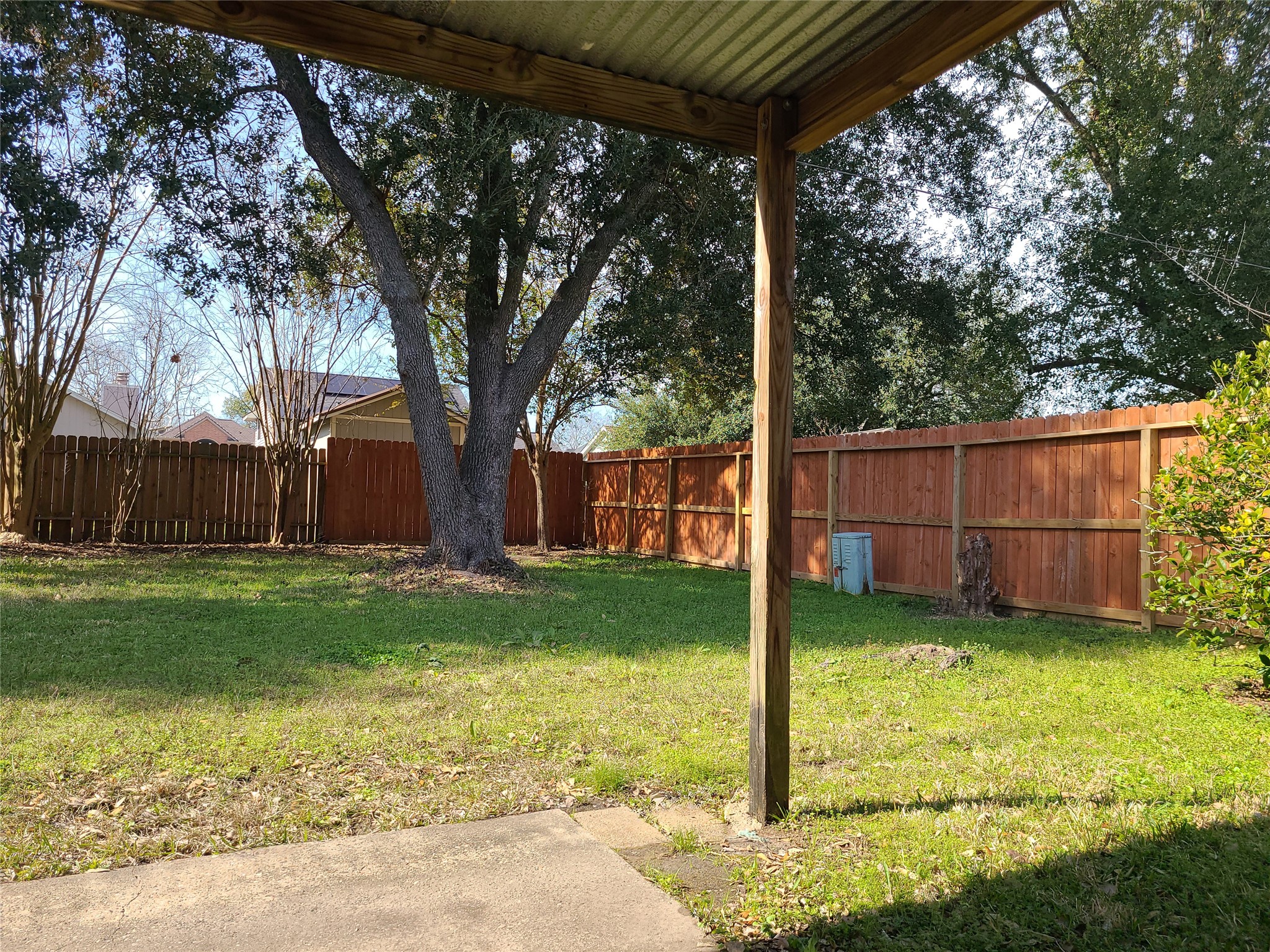 24127 Spring Towne Drive Spring, TX 77373 - Photo 18 of 20 a view of a backyard with large tree and wooden fence