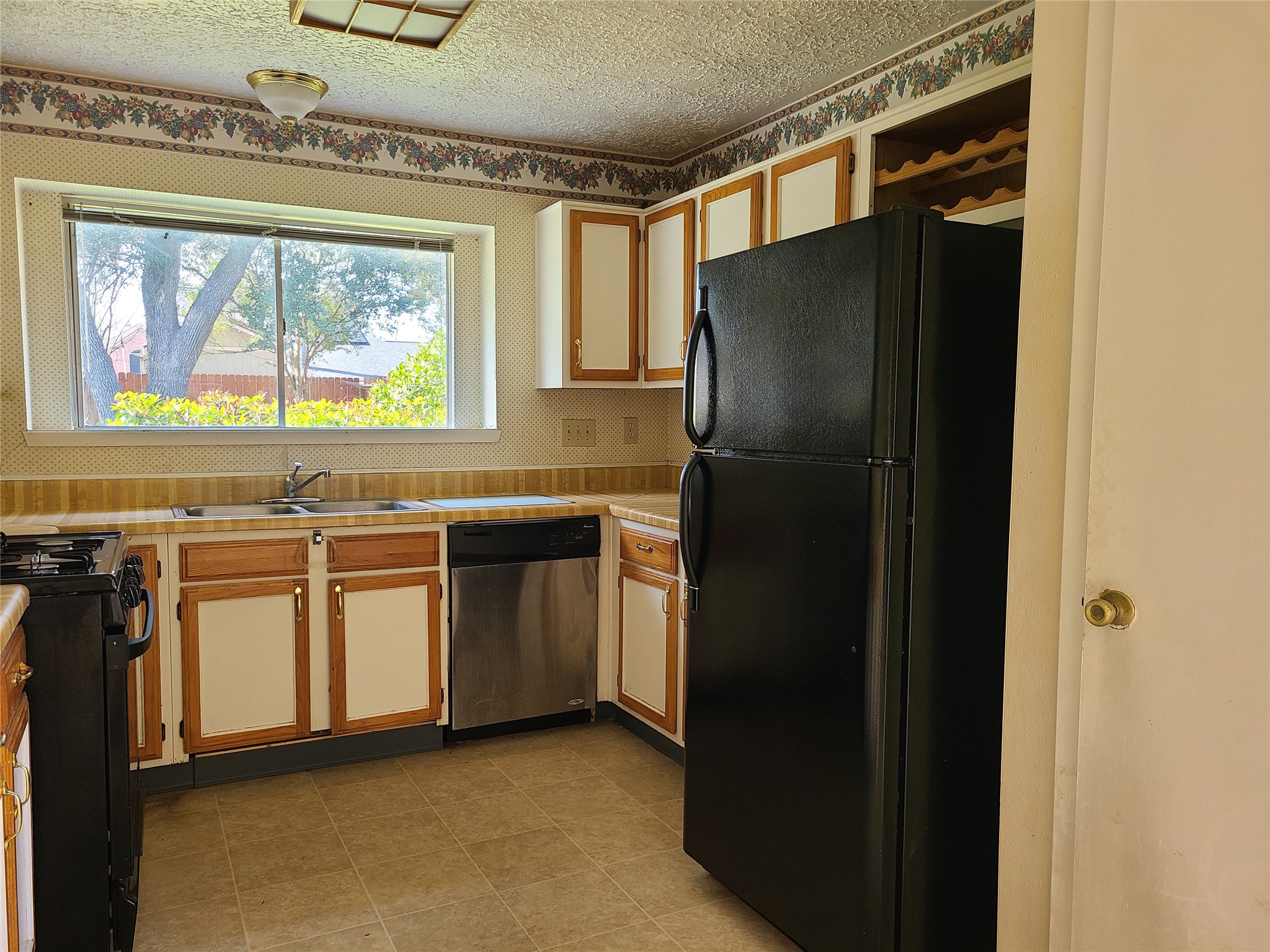 24127 Spring Towne Drive Spring, TX 77373 - Photo 3 of 20 a kitchen with stainless steel appliances granite countertop a refrigerator and a sink