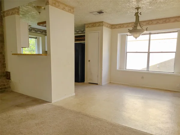 an empty room with windows and entrance