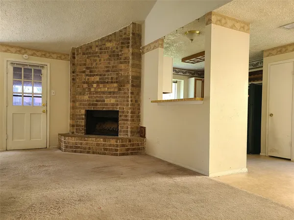 a view of an empty room with a fireplace