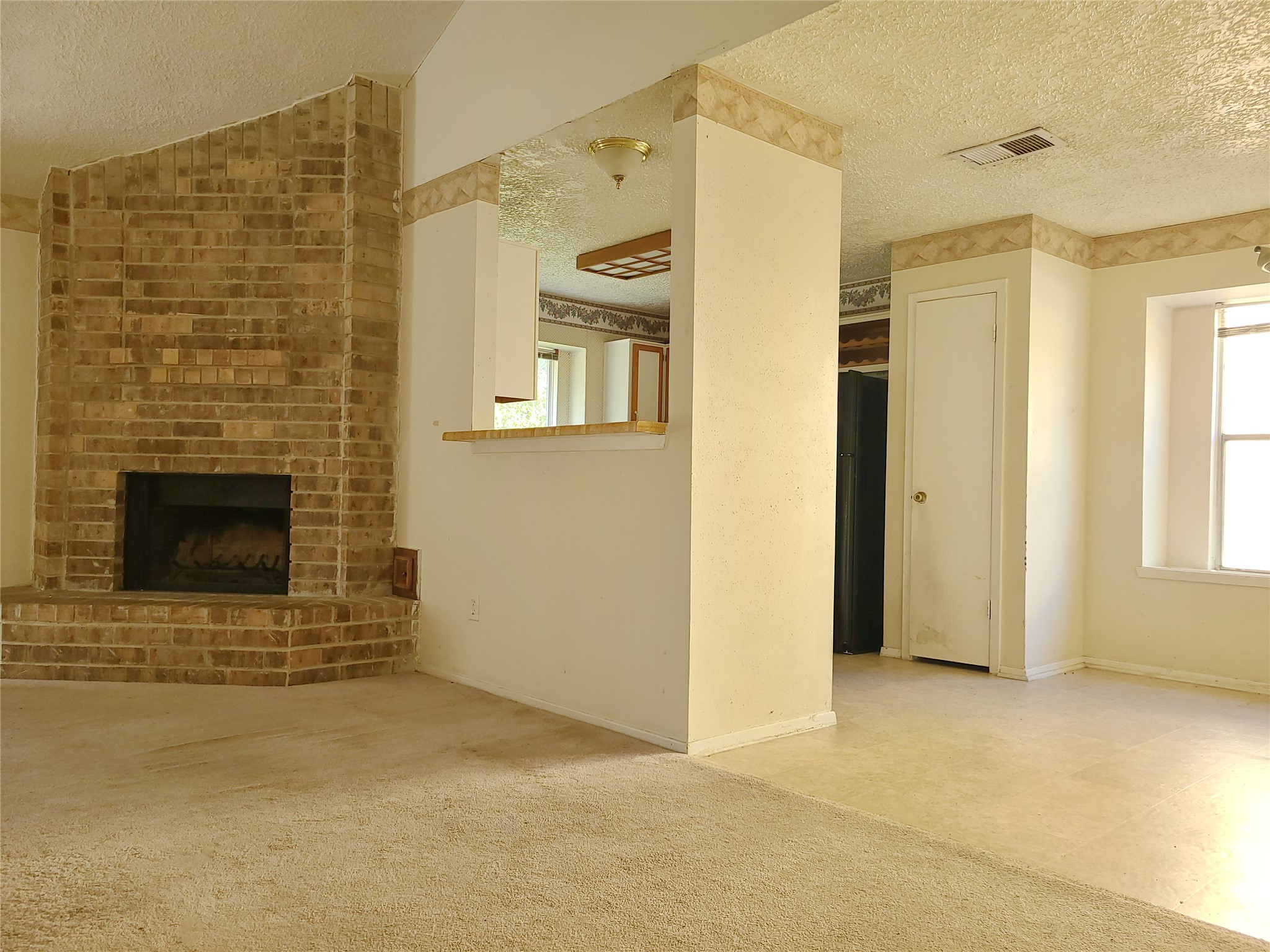 24127 Spring Towne Drive Spring, TX 77373 - Photo 10 of 20 a view of an empty room with a fireplace and a window
