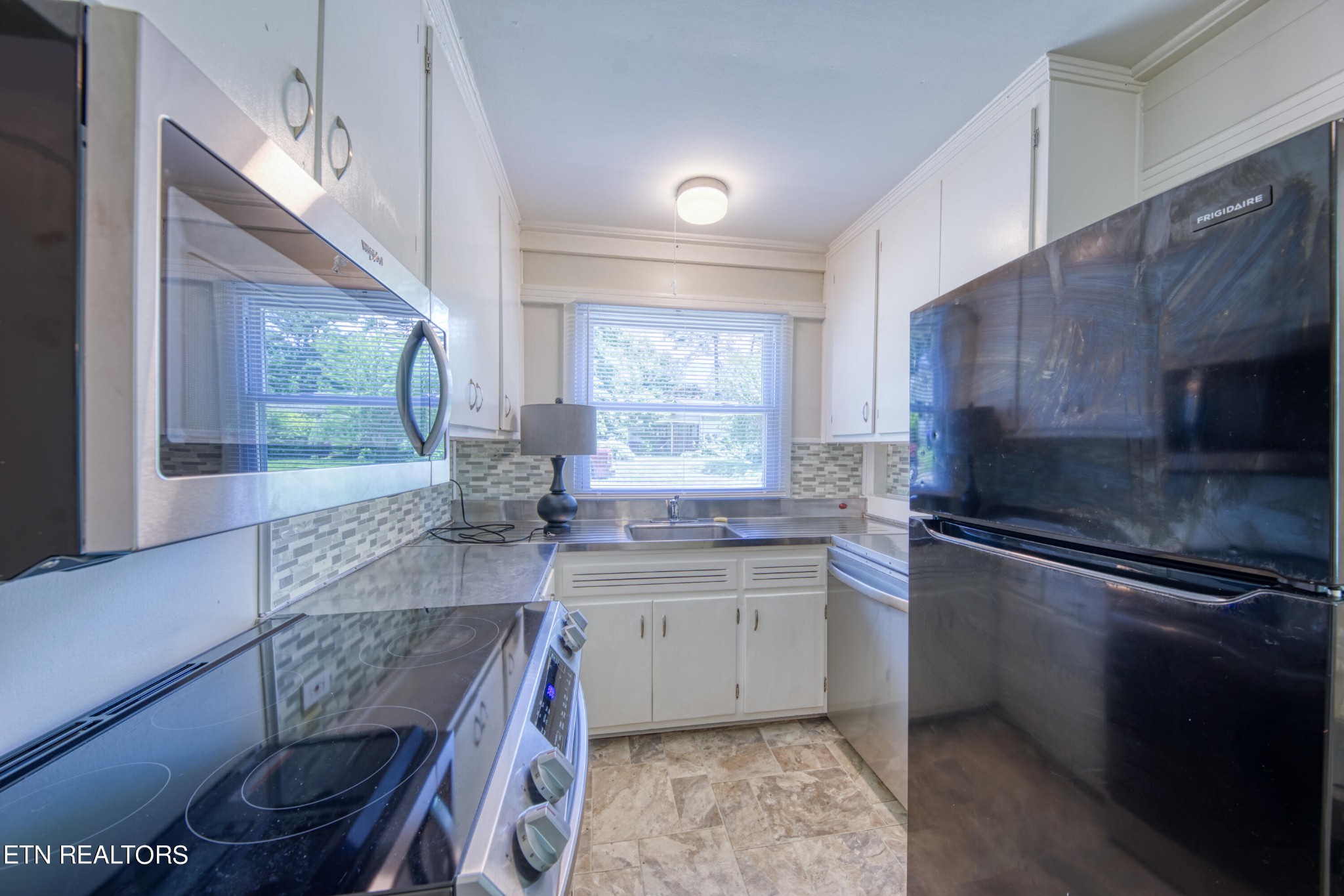 205 West Fairview Road Oak Ridge, TN 37830 - Photo 8 of 21 a kitchen with stainless steel appliances granite countertop a sink stove and refrigerator