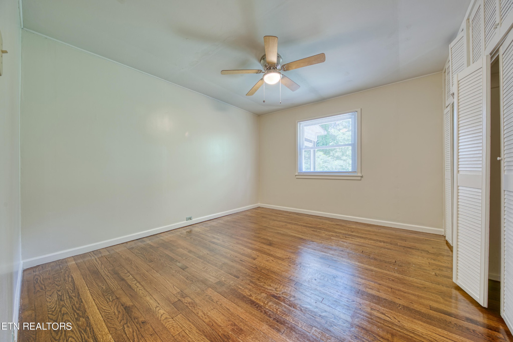 205 West Fairview Road Oak Ridge, TN 37830 - Photo 10 of 21 a view of an empty room with wooden floor and a window