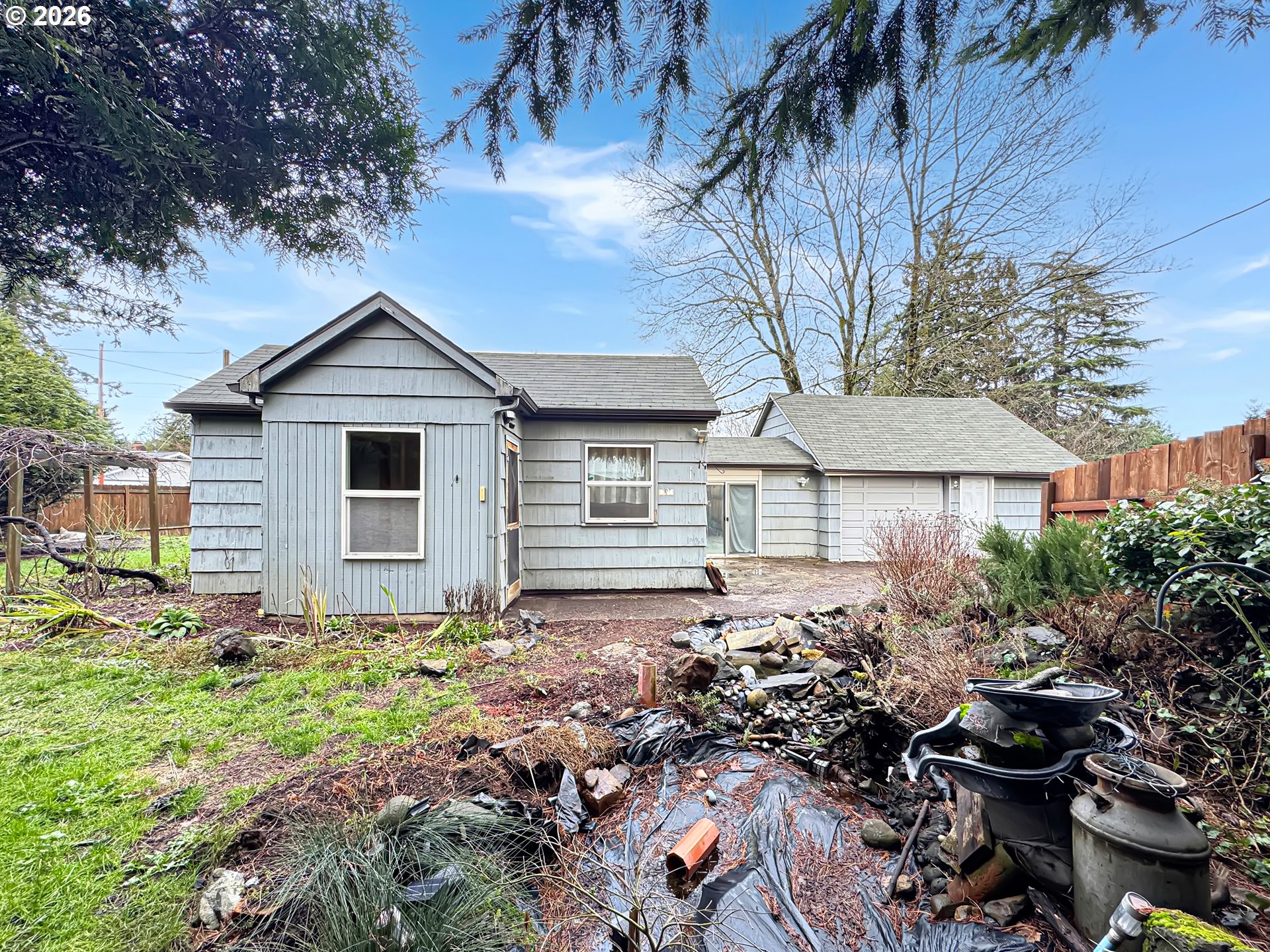 9310 Northeast Burton Road Vancouver, WA 98662 - Photo 23 of 24 a backyard of a house with table and chairs under an umbrella