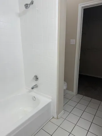 a bathroom with a bathtub and a toilet