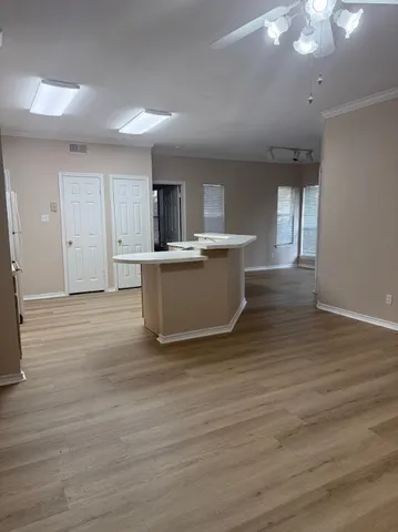 a view of kitchen with stainless steel appliances granite countertop a stove top oven a sink and dishwasher with wooden floor