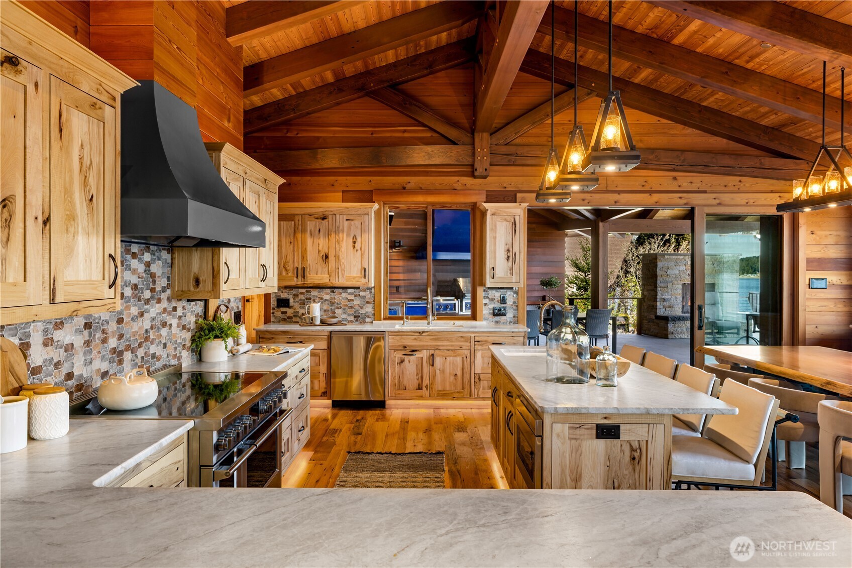 560 Cronquist Road Allyn, WA 98524 - Photo 11 of 39 a view of a patio with dining table and chairs under an umbrella