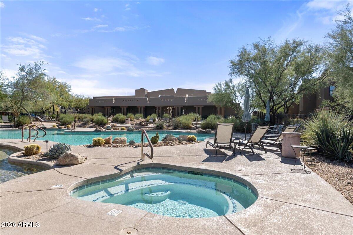 36601 North Mule Train Road, Unit C16 Carefree, AZ 85377 - Photo 35 of 38 a view of a swimming pool with lawn chairs and a fire pit