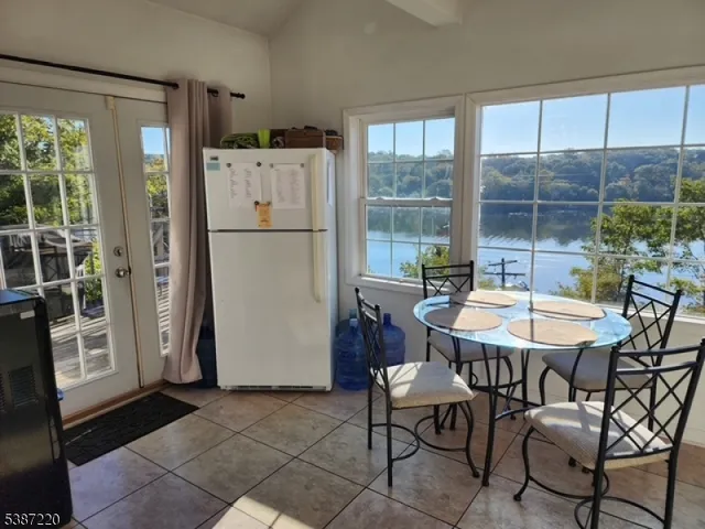 a kitchen with a refrigerator a table and chairs