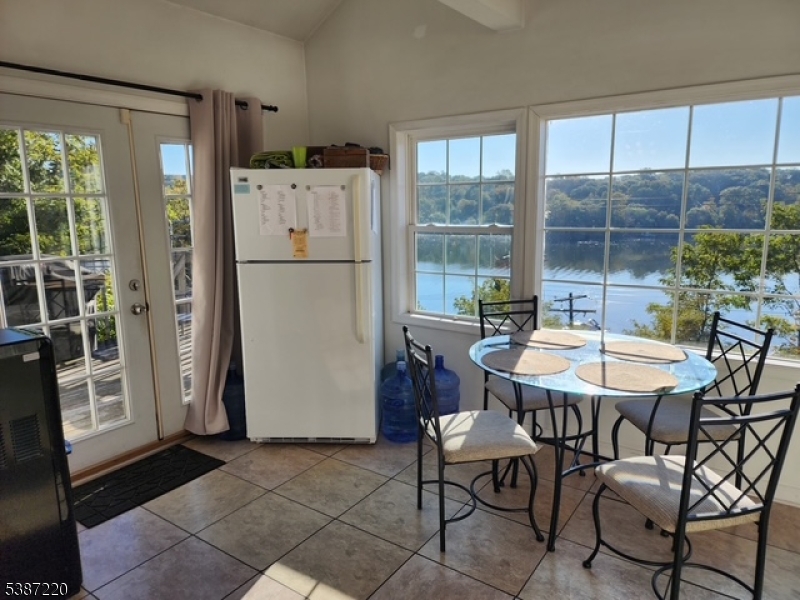 8 Hopatcong Street Hopatcong, NJ 07821 - Photo 13 of 22 a kitchen with a refrigerator a table and chairs