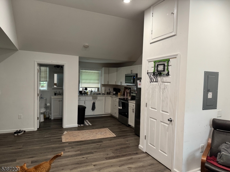 8 Hopatcong Street Hopatcong, NJ 07821 - Photo 15 of 22 a kitchen with white cabinets and wooden floor