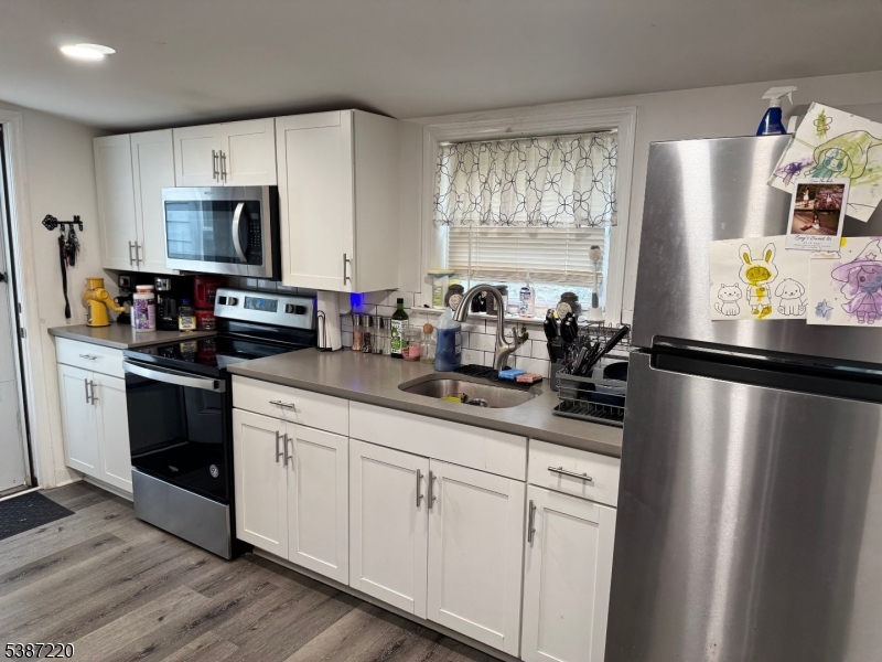 8 Hopatcong Street Hopatcong, NJ 07821 - Photo 16 of 22 a kitchen with stainless steel appliances a sink stove refrigerator and cabinets