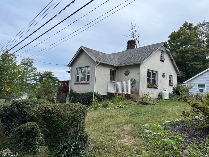 8 Hopatcong Street Hopatcong, NJ 07821 - Photo 6 of 22 a view of a yard in front of a house with plants and large tree