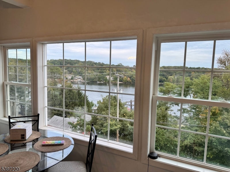 8 Hopatcong Street Hopatcong, NJ 07821 - Photo 8 of 22 a living room with large windows and a table