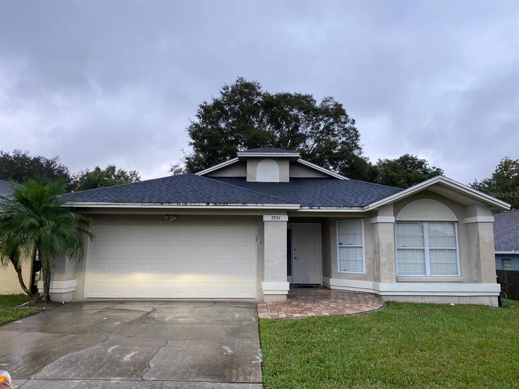 7251 Hunterdon Drive Orlando, FL 32835 - Photo 1 of 1 a front view of a house with a garden and yard