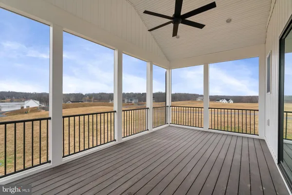 a view of balcony with wooden floor and fence