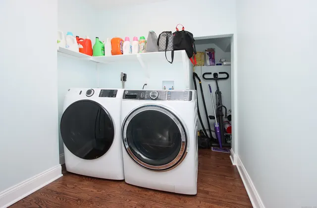 a spacious bedroom with a large bed and a flat tv screen on dresser