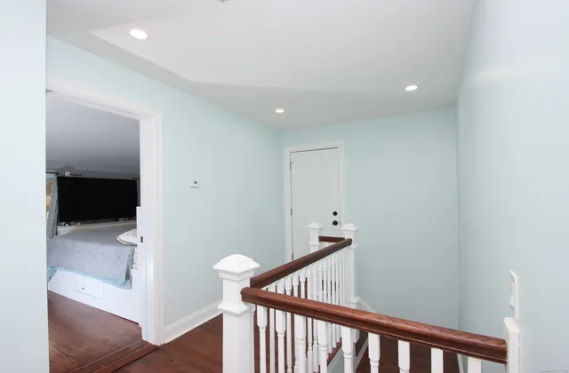 a large white room with a large window and a flat screen tv