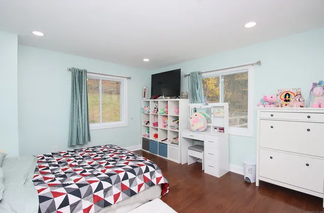 a bedroom with a bed and a dresser