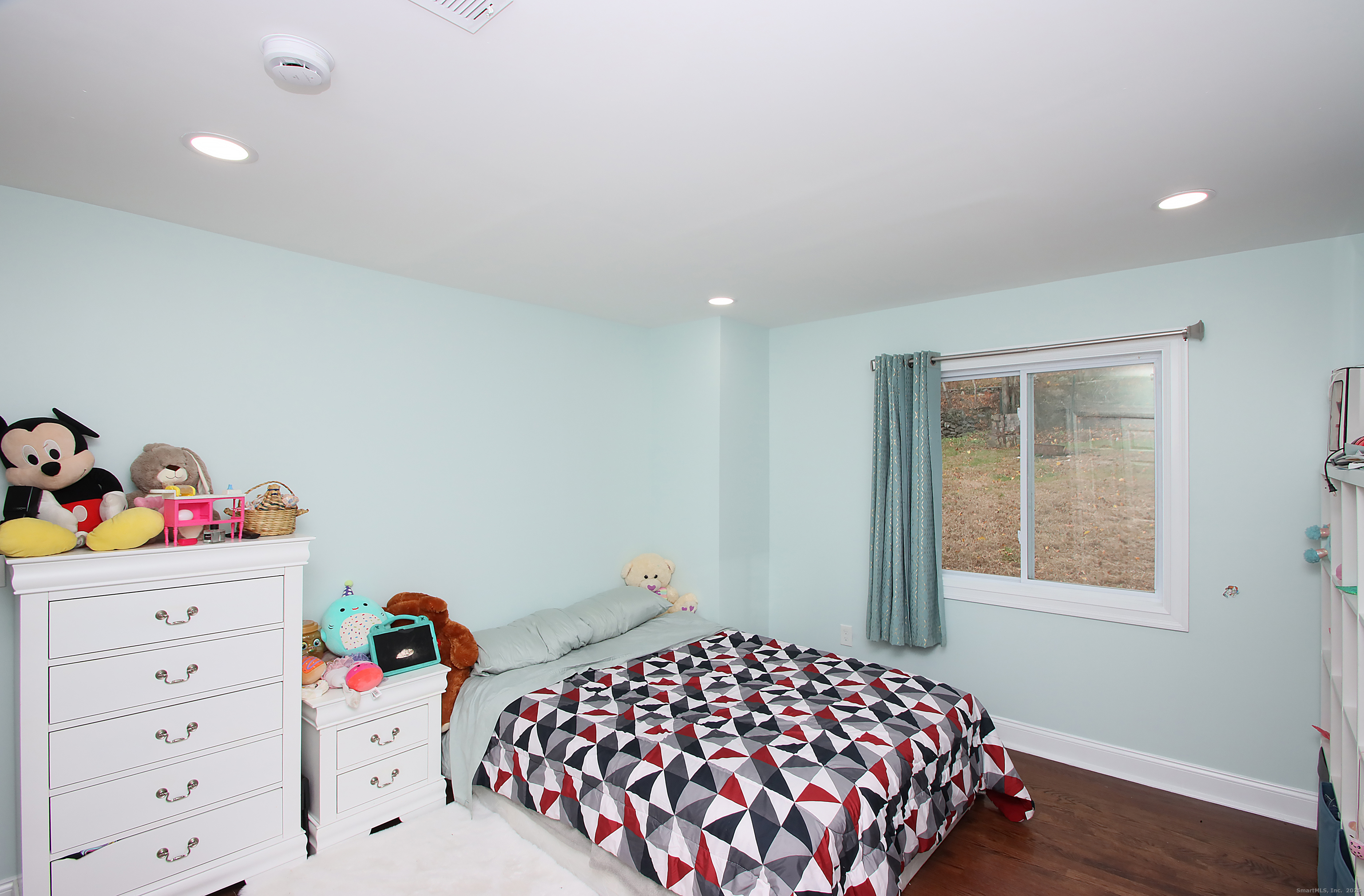 32 Spring Street Ansonia, CT 06401 - Photo 18 of 34 a bedroom with a bed and a dresser