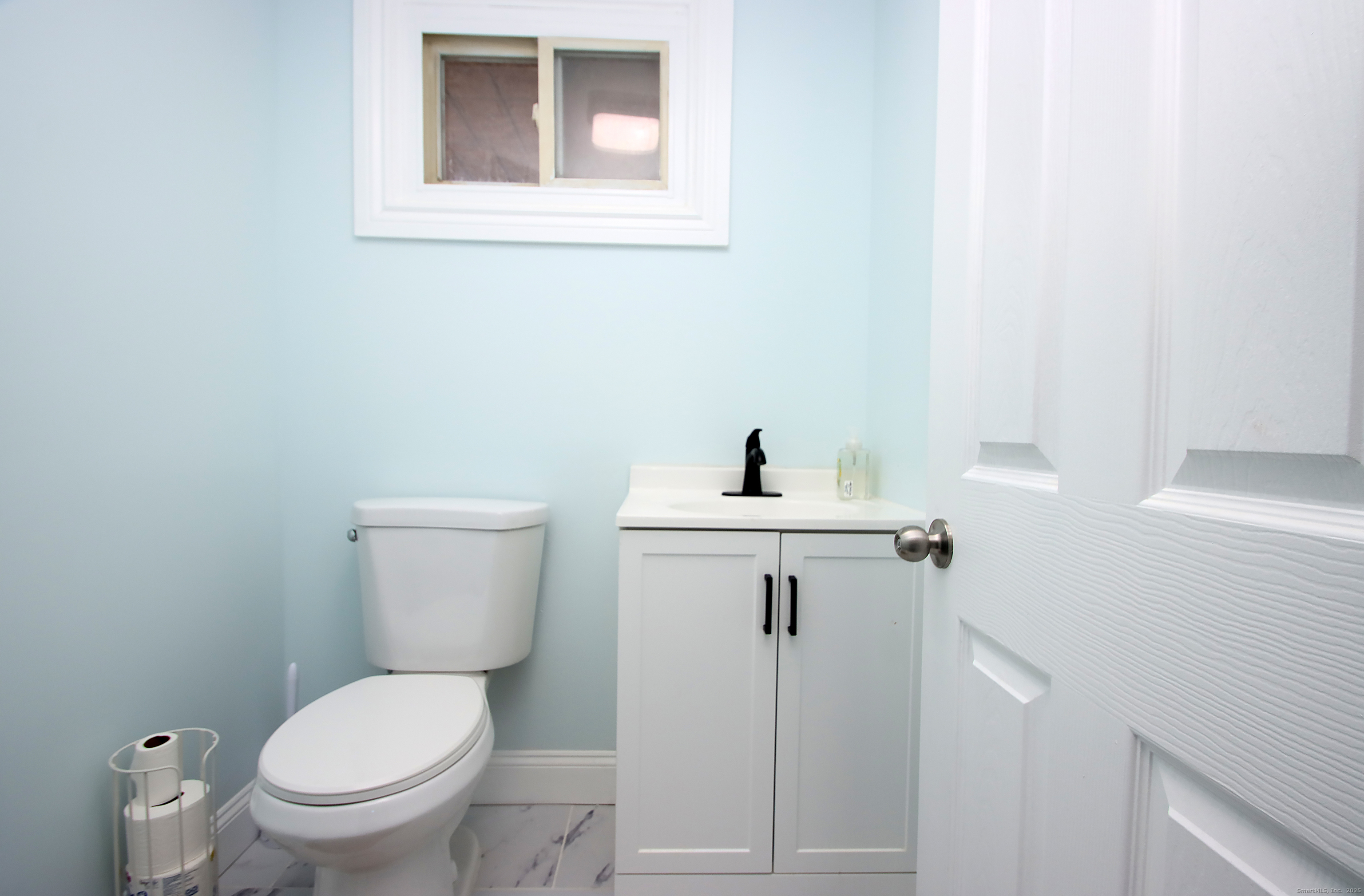 32 Spring Street Ansonia, CT 06401 - Photo 23 of 34 a bathroom with a toilet sink and mirror
