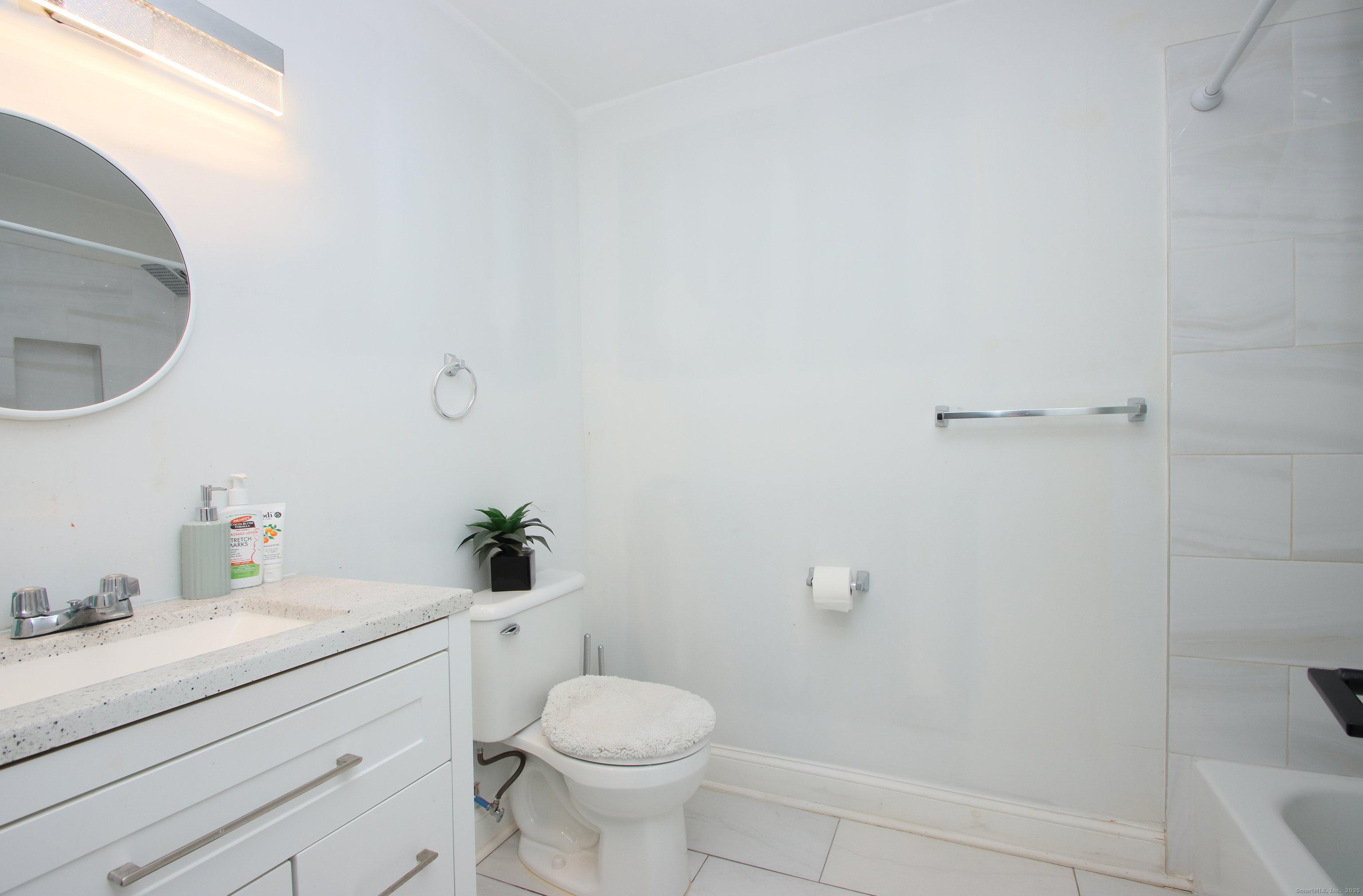 32 Spring Street Ansonia, CT 06401 - Photo 25 of 34 a bathroom with a sink a toilet and a mirror