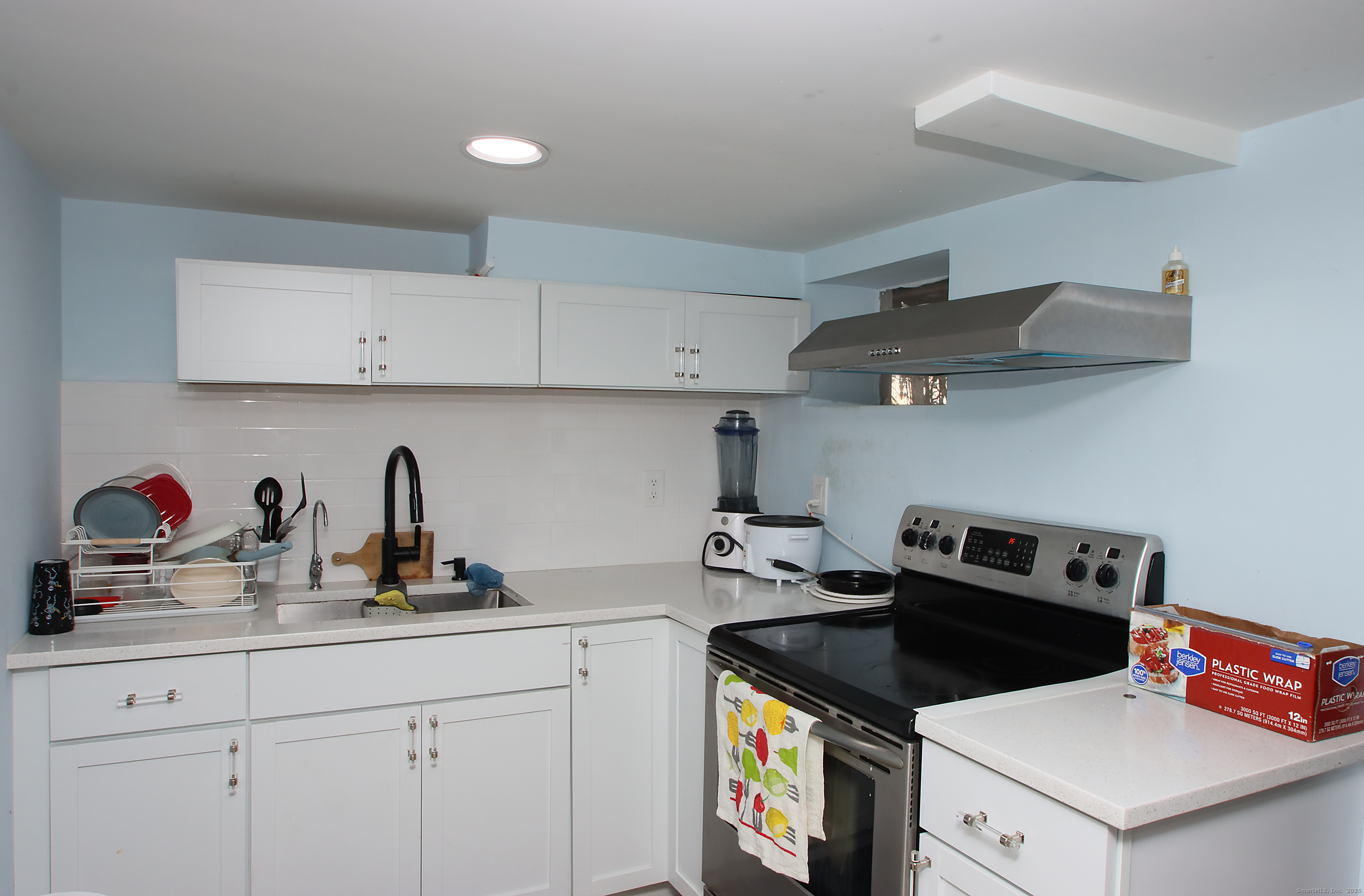 32 Spring Street Ansonia, CT 06401 - Photo 30 of 34 a kitchen with a stove and cabinets