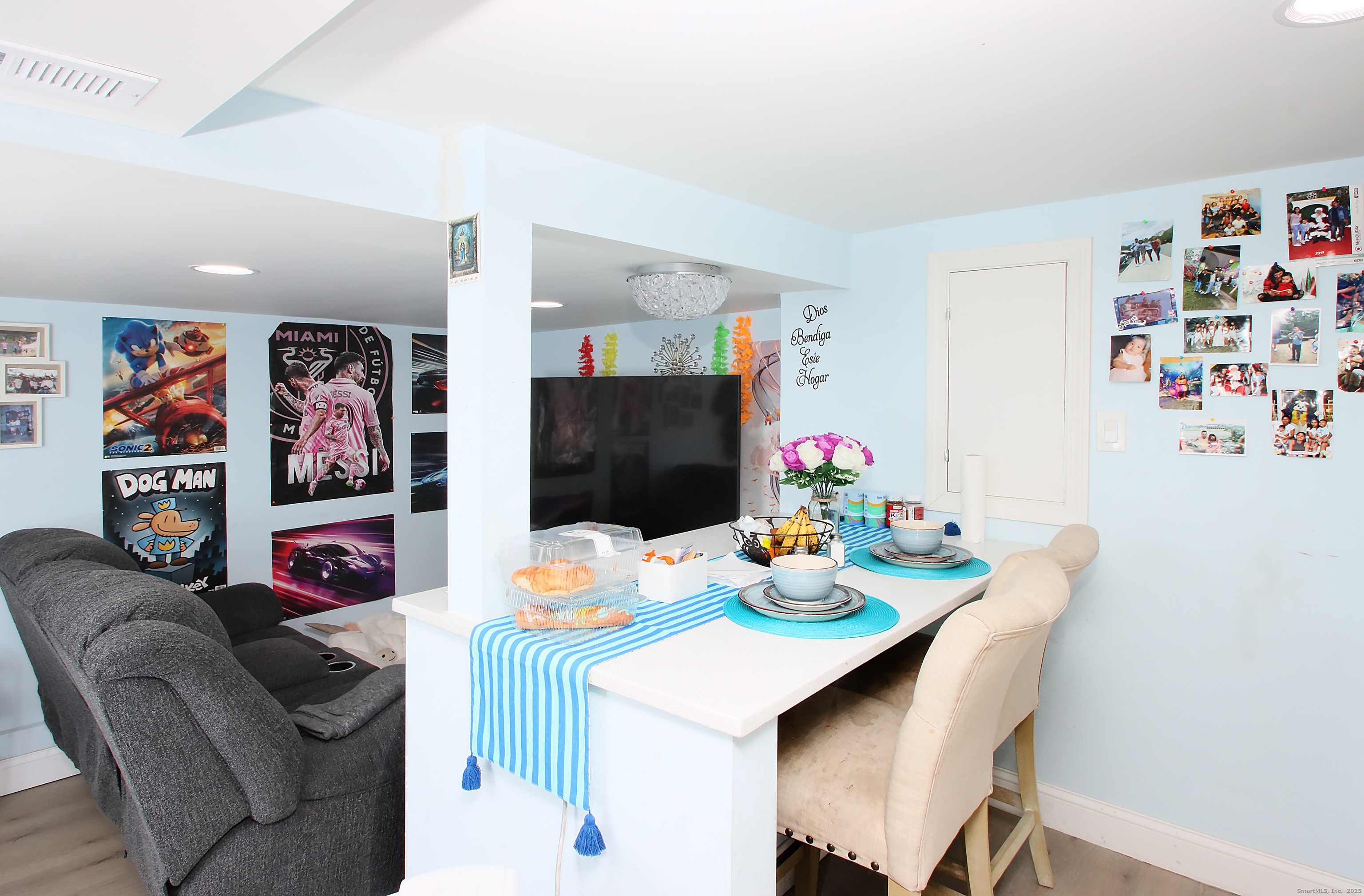 32 Spring Street Ansonia, CT 06401 - Photo 33 of 34 a dining room with furniture a wooden floor and wall paintings