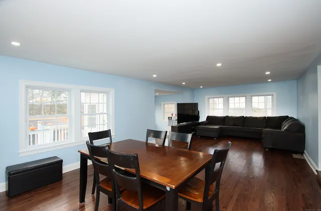 a view of a dining room with furniture and wooden floor