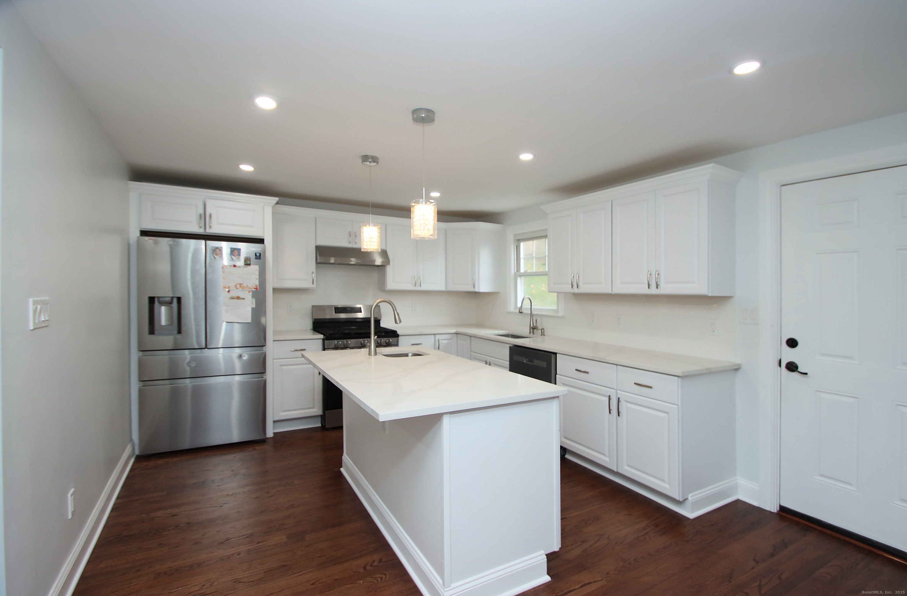 32 Spring Street Ansonia, CT 06401 - Photo 6 of 34 a kitchen with white cabinets and stainless steel appliances