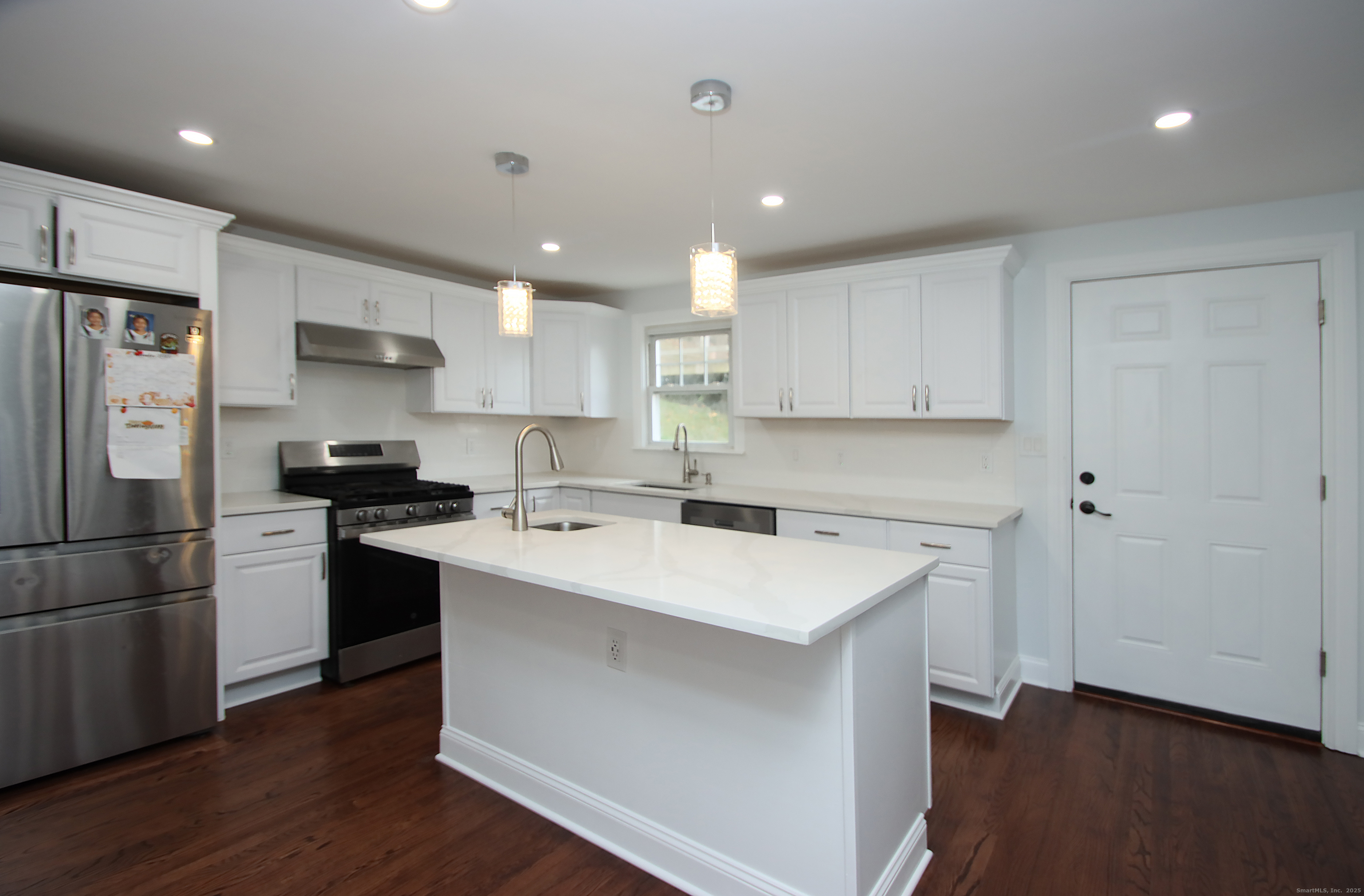 32 Spring Street Ansonia, CT 06401 - Photo 7 of 34 a kitchen with a refrigerator a sink and a stove top oven