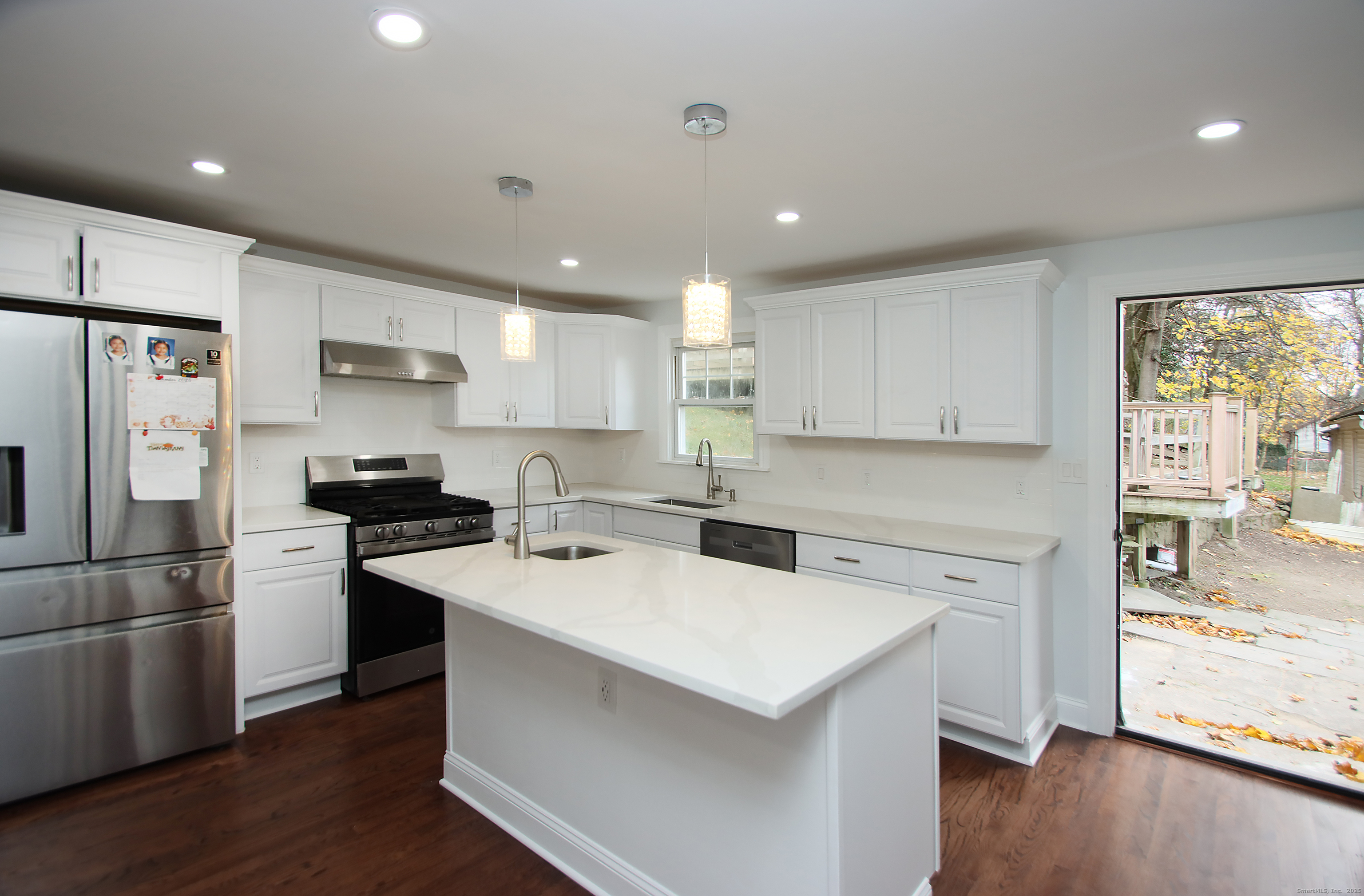 32 Spring Street Ansonia, CT 06401 - Photo 9 of 34 a kitchen with a sink a stove a refrigerator and a microwave
