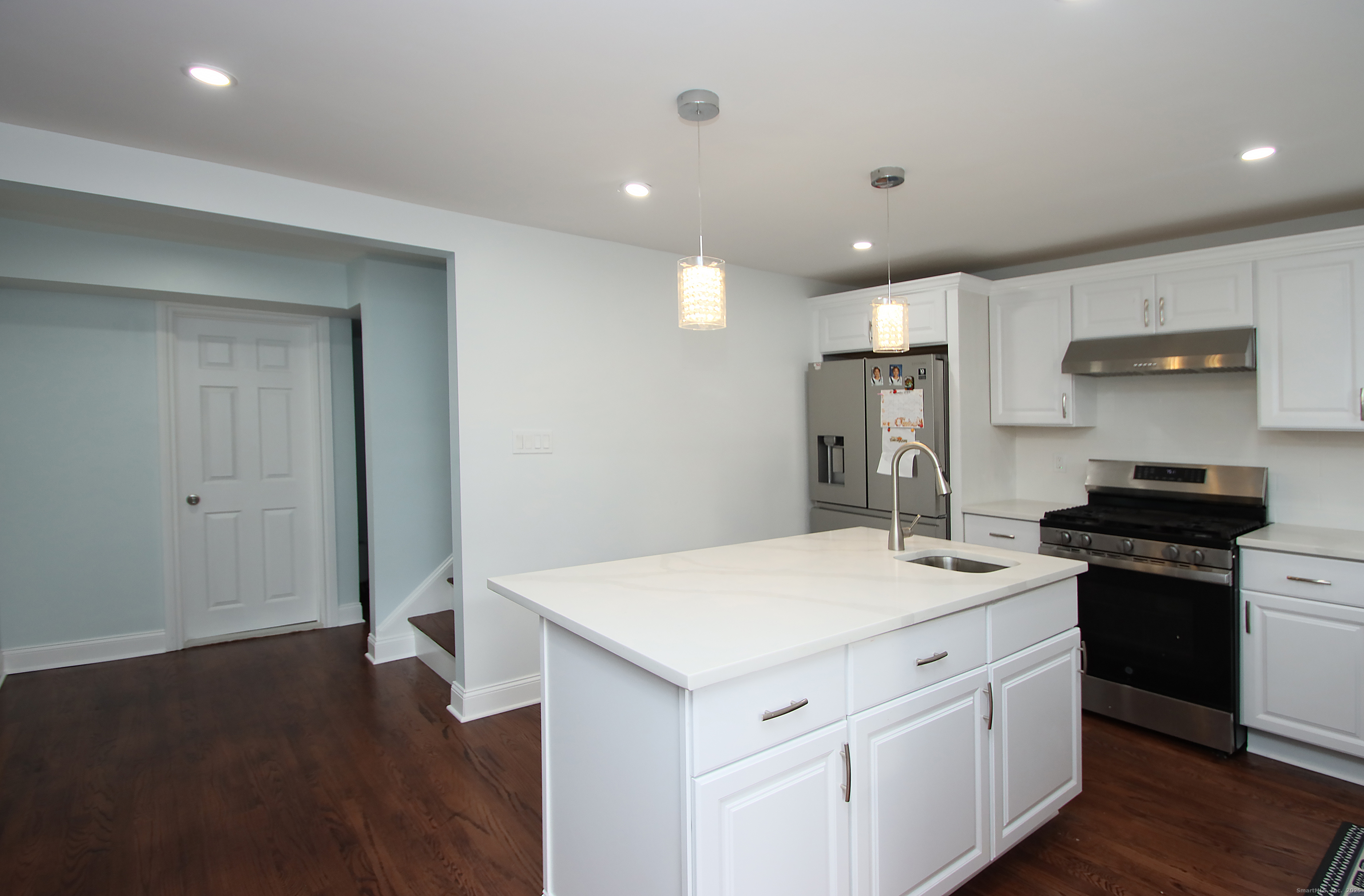 32 Spring Street Ansonia, CT 06401 - Photo 10 of 34 a kitchen that has a sink a stove and a refrigerator