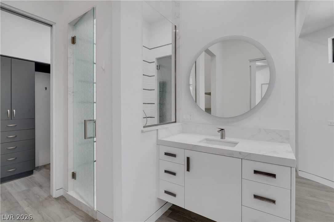 10 Ridge Blossom Road Las Vegas, NV 89135 - Photo 35 of 64 Bathroom with light wood-type flooring, vanity, and a shower stall