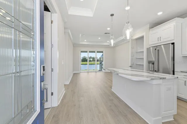 a view of a kitchen with a sink and refrigerator