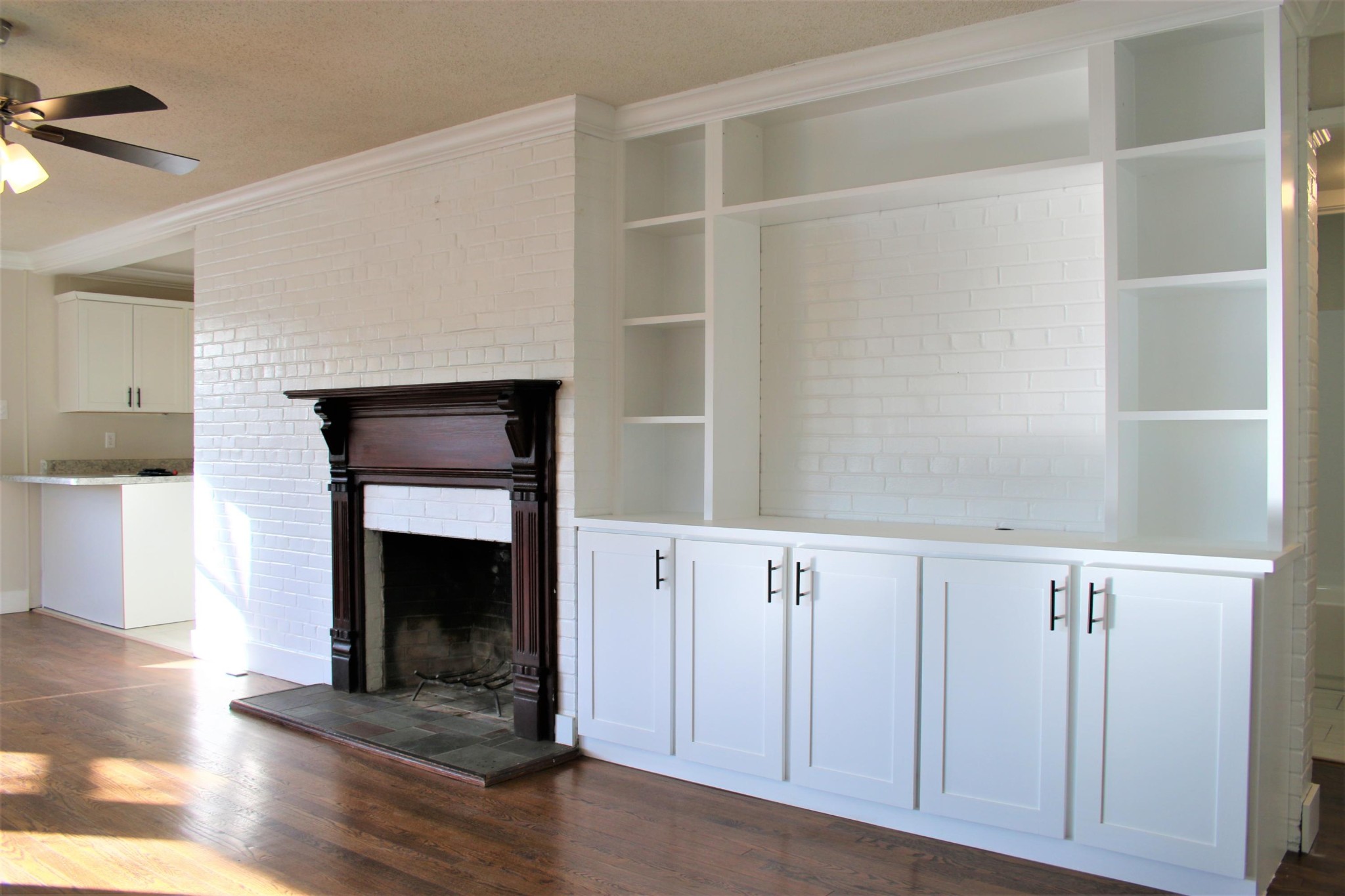 102 Nixon Road Oak Ridge, TN 37830 - Photo 3 of 10 a view of an empty room with wooden floor and a fireplace