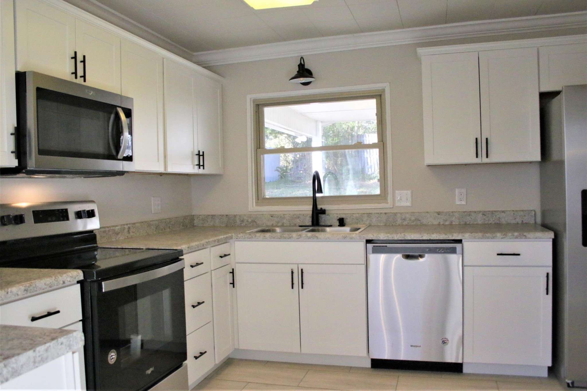 102 Nixon Road Oak Ridge, TN 37830 - Photo 8 of 10 a kitchen with granite countertop a sink cabinets and stainless steel appliances