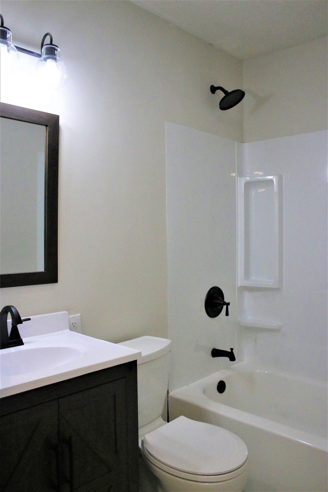 102 Nixon Road Oak Ridge, TN 37830 - Photo 9 of 10 a bathroom with a sink toilet a mirror and shower