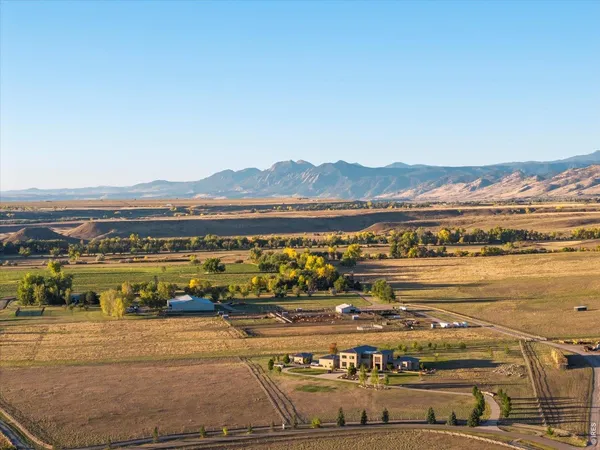 a view of a field with mountains in the background