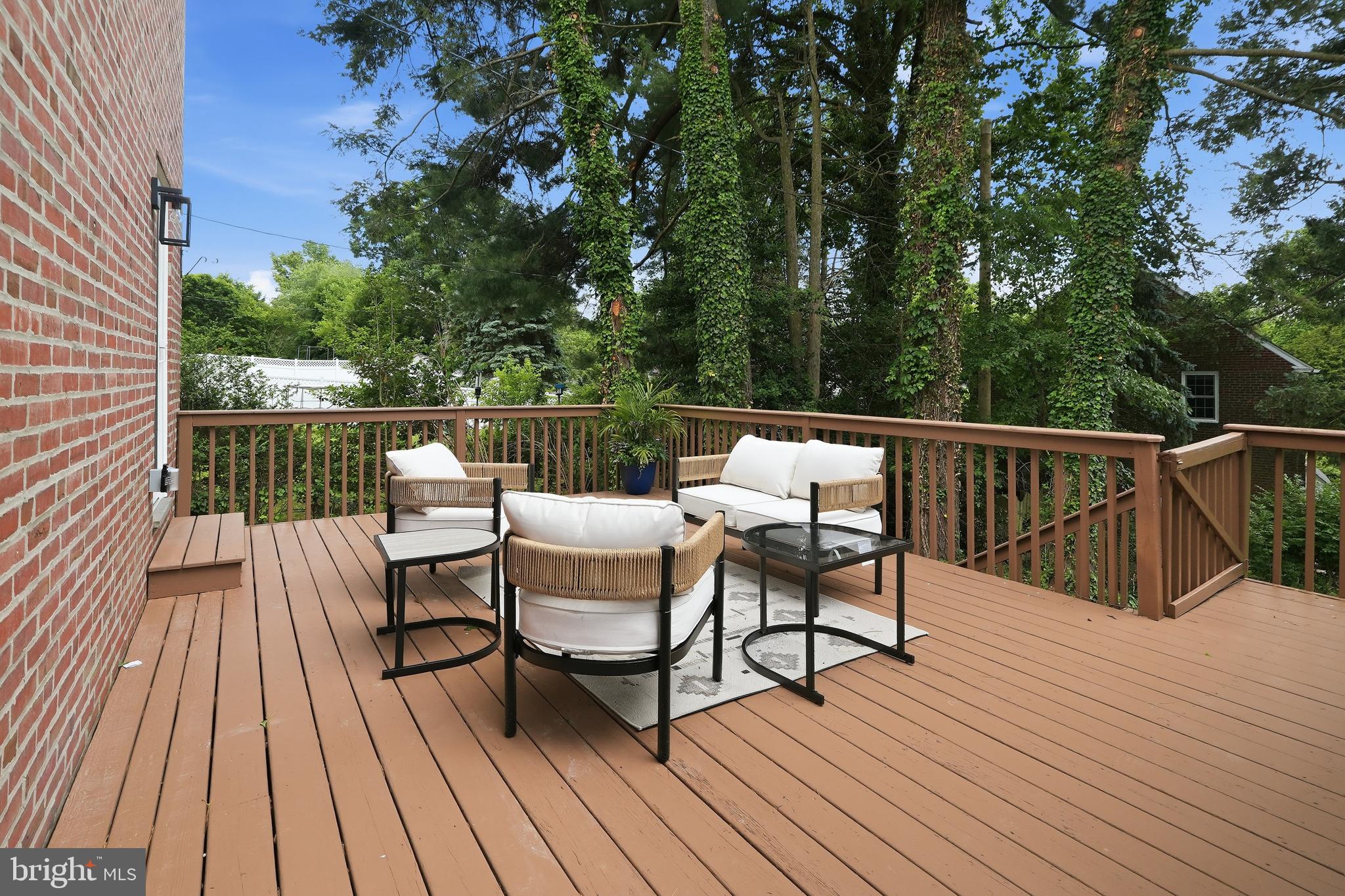 800 Pleasant Hill Road Wallingford, PA 19086 - Photo 18 of 34 a balcony with wooden floor table and chairs