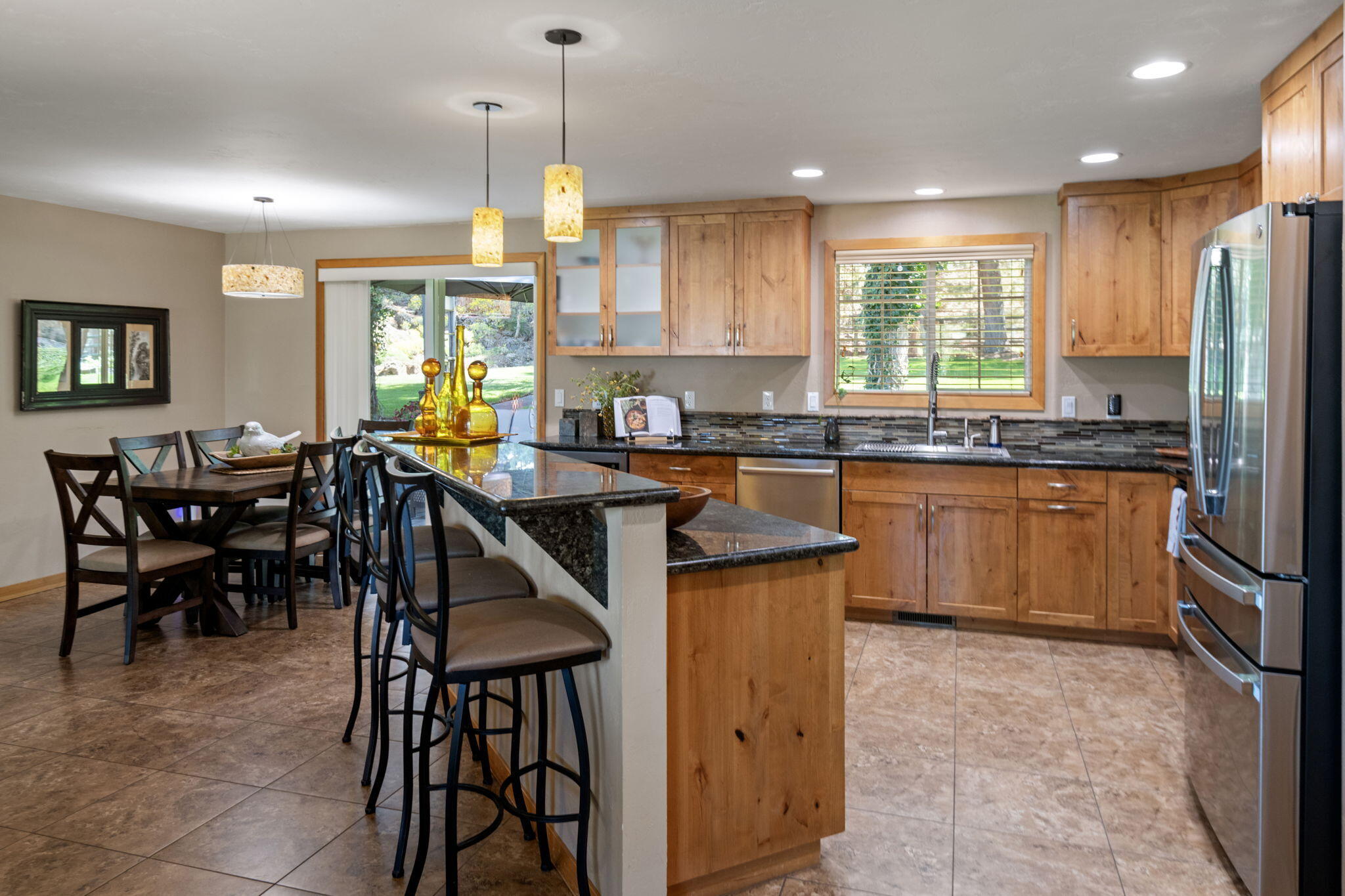 22539 Martee Lane Bend, OR 97701 - Photo 7 of 54 a kitchen with stainless steel appliances granite countertop table chairs sink and window