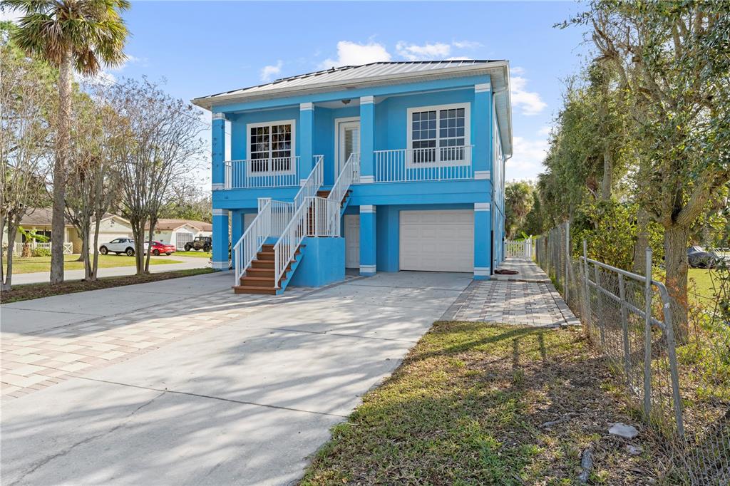 5446 Bluepoint Drive Port Richey, FL 34668 - Photo 11 of 68 a front view of a house with a yard
