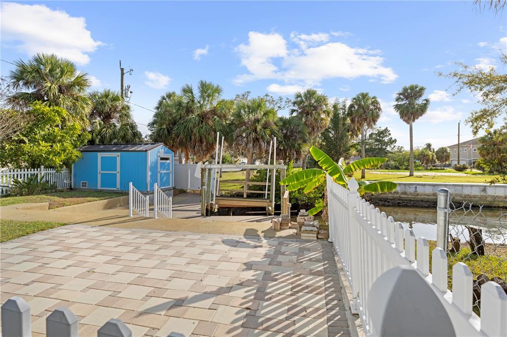 5446 Bluepoint Drive Port Richey, FL 34668 - Photo 15 of 68 a row of palm trees in front of house