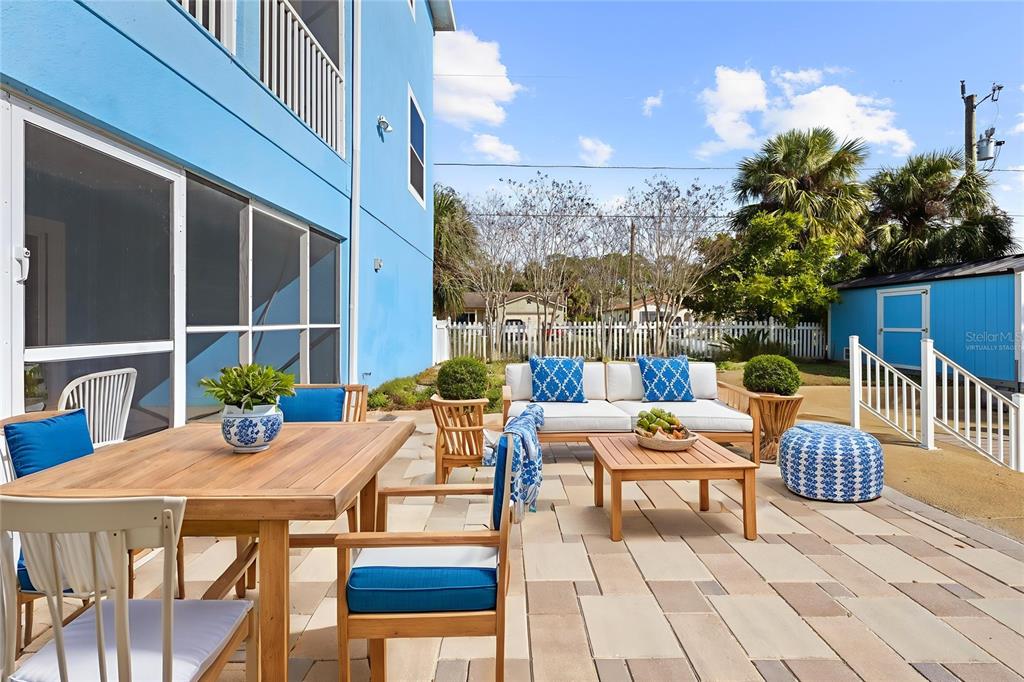 5446 Bluepoint Drive Port Richey, FL 34668 - Photo 16 of 68 a view of a patio with couches table and chairs and potted plants