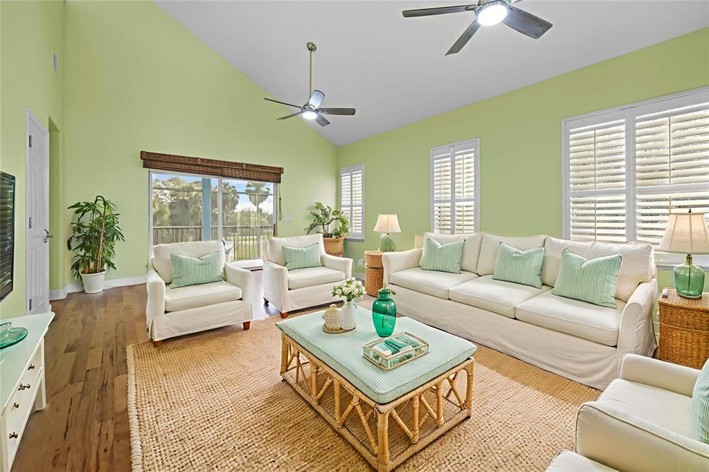 5446 Bluepoint Drive Port Richey, FL 34668 - Photo 32 of 68 a living room with furniture a ceiling fan and a window