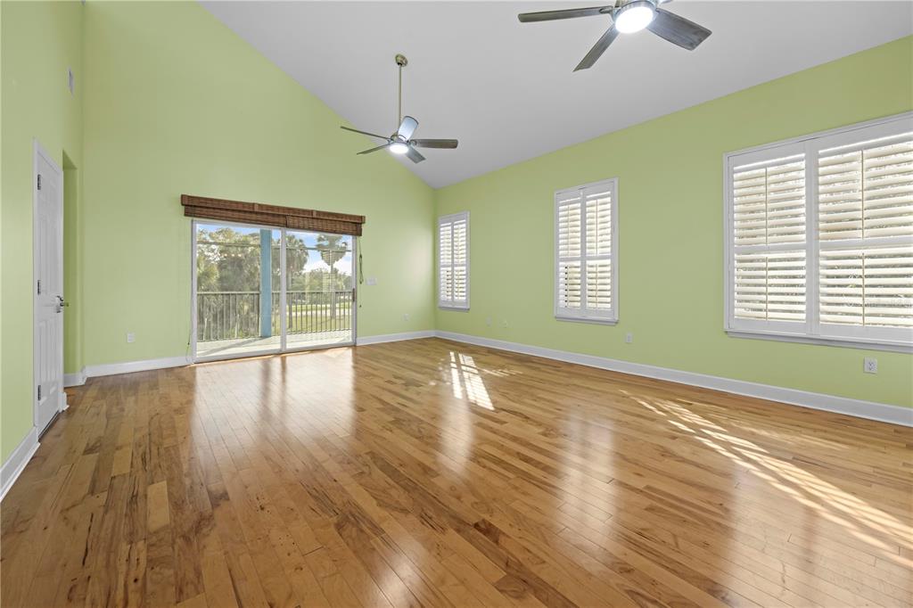 5446 Bluepoint Drive Port Richey, FL 34668 - Photo 33 of 68 a view of empty room with wooden floor and fan
